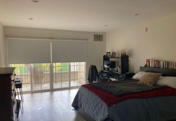 Expertly fitted custom window shades allow perfect light control and privacy on bedroom balcony doors in Mill Valley